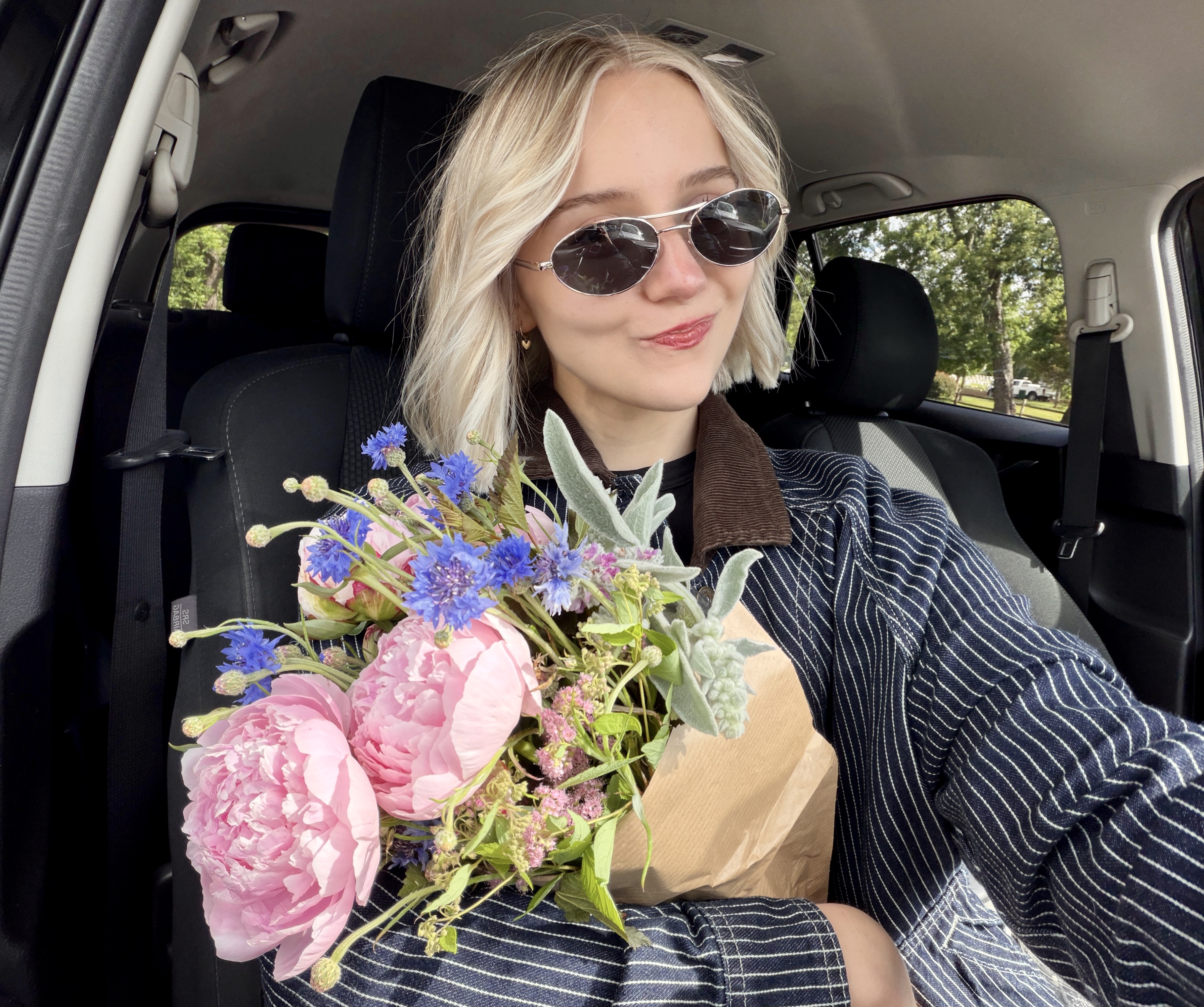 Me holding a bouquet of peonies and wildflowers